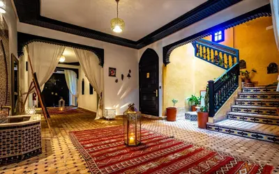 a living room with a staircase and a rug at Dar Biona in Marrakech