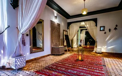 a living room with a rug and a mirror at Dar Biona in Marrakech