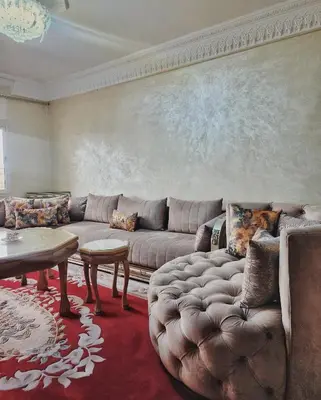 a living room with a couch and a table at logement exceptionnel réservé aux familles in Meknès