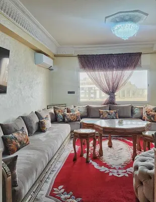 a living room with a couch and a table at logement exceptionnel réservé aux familles in Meknès