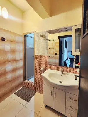 a bathroom with a sink and a mirror and a shower at logement exceptionnel réservé aux familles in Meknès