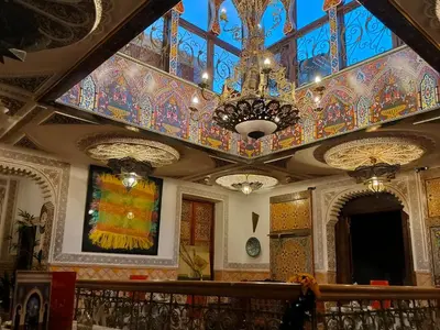 a building with a colorful ceiling and chandelier at Riad Laraichi Palace Suites in Fès