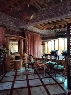 a living room with a table and chairs at Riad Laraichi Palace Suites in Fès