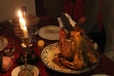 a turkey on a plate on a table with a candle at Kasbah Itrane in Tamnougalt