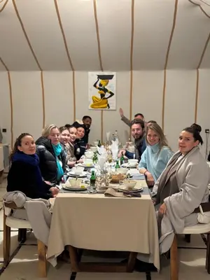 a group of people sitting at a table at Camp Sakura Desert Dream in Merzouga