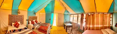 a room with a tent with a bed and a window at Riad Ksar Merzouga in Merzouga