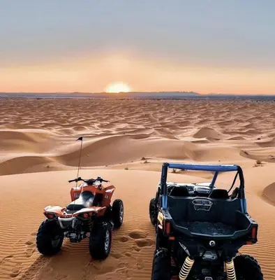 two atvs and a quad bike in the desert at Merzouga Alicante Luxury Camp in Merzouga