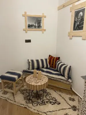 a living room with a couch and a table at Dar Mgouna Roses in Kalaat MGouna