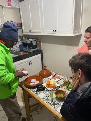 a group of people in a kitchen preparing food at Dar Mgouna Roses in Kalaat MGouna
