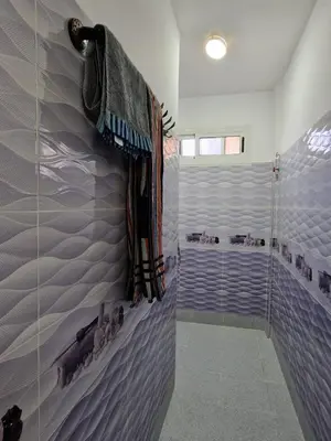 a bathroom with a shower with ducks on the wall at Dar Latifa in Tinerhir