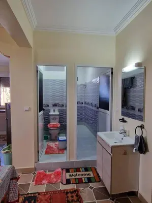 a bathroom with a shower with a toilet and a sink at Dar Latifa in Tinerhir