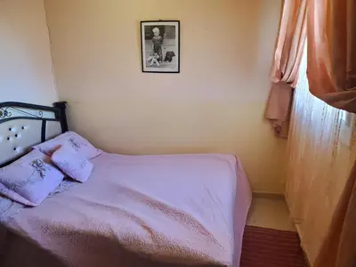 a bedroom with a bed and a picture on the wall at La belle vue in Ifrane