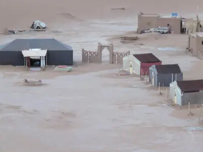 a group of buildings in the middle of a desert at Chegaga Berber Camps in Mhamid