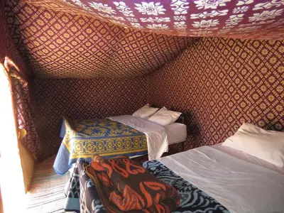 a small room with two beds in a tent at Chegaga Berber Camps in Mhamid