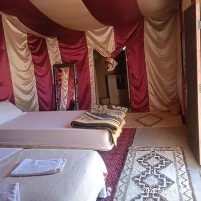 a room with two beds in a tent at Chegaga Berber Camps in Mhamid