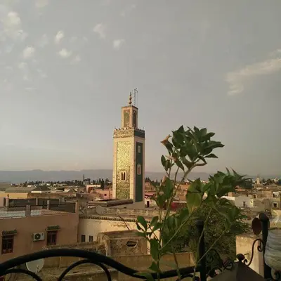 a clock tower in the middle of a city at Riad Selma in Meknès