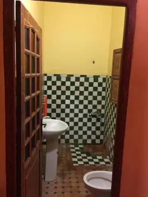 a bathroom with a sink and a toilet at Riad Selma in Meknès