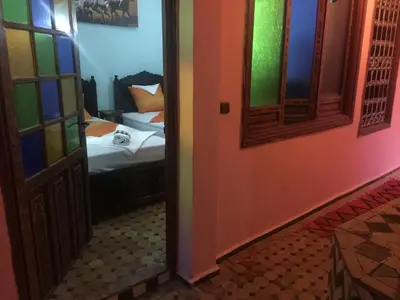 a room with a bedroom with a bed and a door at Riad Selma in Meknès
