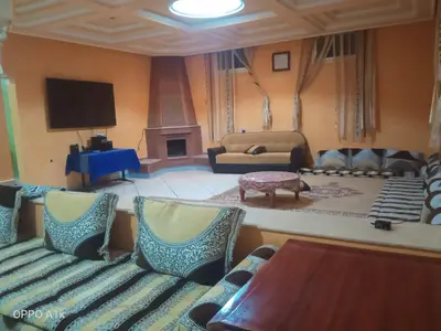 a living room with a couch and a tv at chez l'habitant amazigh in Ouarzazate