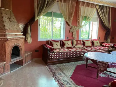 a living room with a couch and a fireplace at chez l'habitant amazigh in Ouarzazate