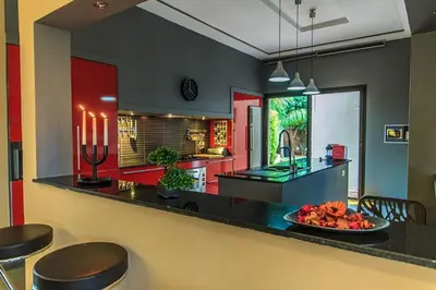 a kitchen with a counter with a plate of fruit on it at Villa 751, Villa d'architecte, cuisinière, piscine chauffée et services in Marrakech
