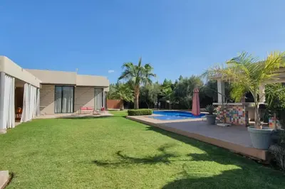 a house with a yard with a swimming pool at Villa 751, Villa d'architecte, cuisinière, piscine chauffée et services in Marrakech