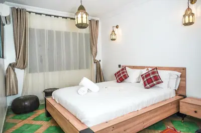 a bedroom with a bed and a window at Villa Tifira in Marrakech