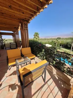 a patio with two chairs and a table on a patio at Villa Tifira in Marrakech