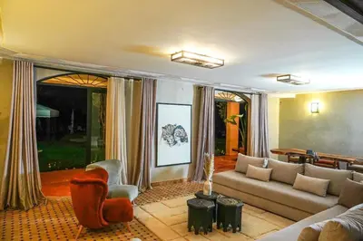 a living room with a couch and a chair at Villa Tifira in Marrakech