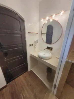 a bathroom with a mirror and a white sink at Villa Tifira in Marrakech