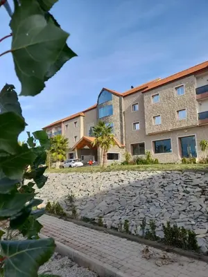 a building with a stone courtyard in front of it at AUBERGE JOMANA PARK in Azrou