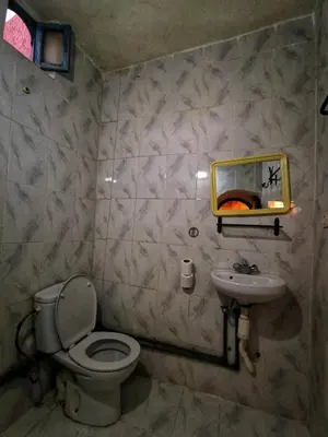 a bathroom with a toilet and a sink at Kasbah Ziwana - Guesthouse in Zagora