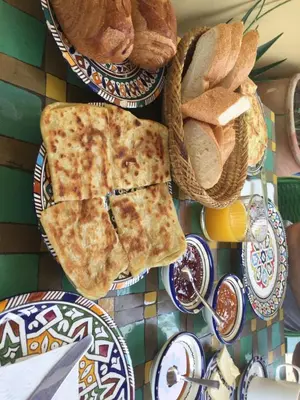 a table with plates of bread and slices of pizza at Hostel Speakeasy Fes in Fès