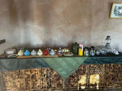 a table with bowls and other items on it at Auberge Camping La Libertè in Merzouga