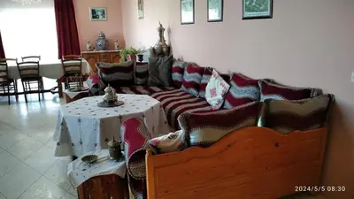 a living room with a couch and a table at Domaine des Sloughis in Meknès