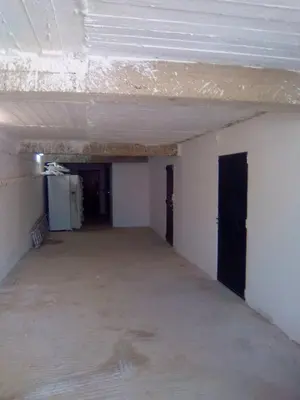 an empty room with a concrete floor and a white ceiling at Domaine des Sloughis in Meknès