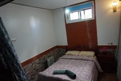 a bedroom with a bed and a window at SamIfrane1 in Zaouia dʼIfrane