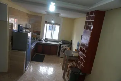 a small kitchen with a refrigerator and a stove at SamIfrane1 in Zaouia dʼIfrane