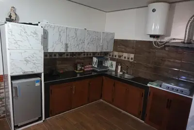 a kitchen with a sink and a refrigerator at SamIfrane1 in Zaouia dʼIfrane