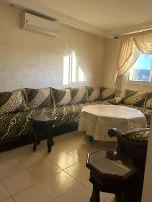 a living room with a couch and a table at Marwan's apartment Ifrane Gardens in Ifrane