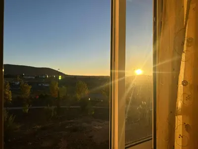 a view of the sunset from a window at Marwan's apartment Ifrane Gardens in Ifrane