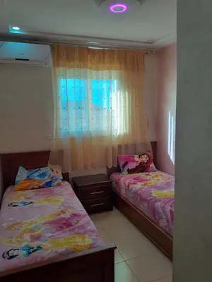 a bedroom with two beds and a window at Marwan's apartment Ifrane Gardens in Ifrane