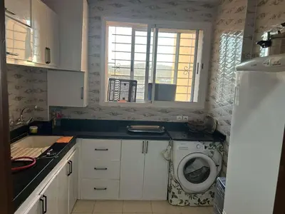 a kitchen with a washing machine and a window at Marwan's apartment Ifrane Gardens in Ifrane