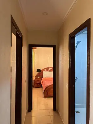 a hallway with a bedroom with a bed in it at Marwan's apartment Ifrane Gardens in Ifrane