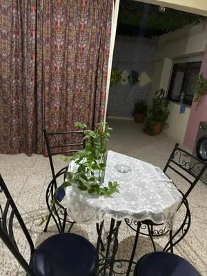 a table and chairs with a plant on it at Tranquility In the Center of Fez in Fès