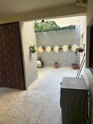 an open door to a courtyard with potted plants at Tranquility In the Center of Fez in Fès