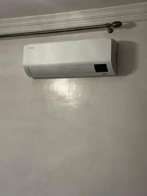 a white smoke detector hanging on a wall at Tranquility In the Center of Fez in Fès