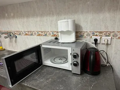 a microwave with a coffee maker on top of it at Tranquility In the Center of Fez in Fès