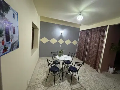 a dining room with a table and four chairs at Tranquility In the Center of Fez in Fès