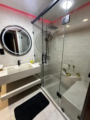a bathroom with a shower and a sink and a mirror at Tranquility In the Center of Fez in Fès